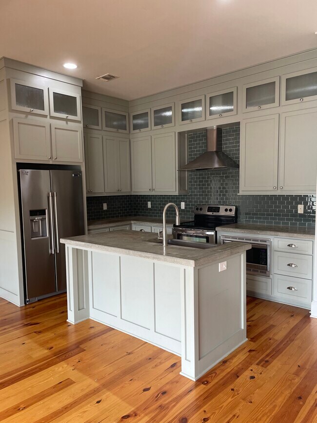 Kitchen with concrete counter tops open to living room - 9 Town Center Sq