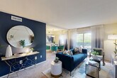 Located at 8729 Contee in Laurel, MD, this thoughtfully designed one-bedroom, one-bathroom residence offers a comfortable and stylish single-floor layout. The living room serves as the heart of the home, highlighted by a bold navy accent wall, a sliding glass door that opens to a private balcony, and abundant natural light that enhances the warm carpeted floors throughout. The space flows seamlessly into a dedicated dining area, illuminated by a pendant light fixture and framed by large windows dressed with elegant ombre curtains. The kitchen is equipped with stainless steel appliances, light wood cabinetry, dark countertops, and tile flooring, providing a functional and efficient cooking space. The spacious primary bedroom features a decorative wainscoting accent wall and plush carpeting, creating a serene retreat. The full bathroom includes a tiled tub-shower combination, a vanity with storage, and tile flooring. Three closets are distributed throughout the home, offering generous storage solutions. A hallway connects the living areas to the private quarters, contributing to a logical and well-organized floor plan. Overall, this residence combines practical functionality with contemporary design details.