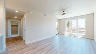 Located at 2100 Fourth Avenue in San Diego, CA, this modern 4-bedroom, 1-bathroom home offers a thoughtfully designed single-floor layout with high-quality finishes throughout. The open-concept kitchen and living area serves as the heart of the home, featuring light wood-look flooring, recessed and pendant lighting, and a ceiling fan. The kitchen is equipped with stainless steel appliances — including a French door refrigerator, gas range, microwave, and dishwasher — complemented by crisp white shaker cabinetry, a tile backsplash, and ample counter space. The living room is bright and airy, with large windows and direct access to a private balcony that brings in abundant natural light and outdoor views of the surrounding San Diego landscape. The four bedrooms are well-proportioned, with the primary bedroom offering generous space. Bedrooms feature plush carpeting, ceiling fans, and large windows with tree-lined views. The bathroom is elegantly appointed with a frameless glass walk-in shower, an LED-backlit vanity mirror, white cabinetry, and wood-look tile flooring. Two closets and a hallway round out the functional layout, making this a well-equipped home in a prime urban location.