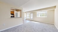 Located at 5024 Call Pl SE in Washington, DC, this two-bedroom, one-bathroom residence is designed for comfortable, efficient living on a single floor. The open living room is a welcoming centerpiece, featuring plush wall-to-wall carpeting, neutral beige walls, and an abundance of natural light streaming through large windows and a glass-paneled door that overlooks the outdoors. A pass-through counter connects the living area to the kitchen, which is equipped with warm wood cabinetry, a stainless steel sink, electric range, and a full-size refrigerator, all set over easy-care hardwood-style flooring. Both bedrooms continue the carpeted, light-toned aesthetic and are well-served by generous closet space — the primary bedroom features a dedicated closet with a hanging rod, while the second bedroom benefits from two closets, offering ample storage. Each bedroom receives natural light through its own window with views of the surrounding neighborhood. The full bathroom is clean and straightforward, with white tile flooring, a tiled tub-shower combination, and classic white fixtures. With three total closets throughout the home, storage is a practical highlight of this thoughtfully laid-out residence.