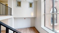 Located at 160 Seabury St in Fall River, MA, this two-floor residence offers three bedrooms and two bathrooms across a well-organized layout. The lower floor serves as the main living level, featuring warm light wood flooring, recessed lighting, and an open area adjacent to a kitchen equipped with stainless steel appliances, white cabinetry, and a subway tile backsplash. A sleek staircase with black metal railings connects the floors, rising beneath soaring ceilings that enhance the sense of openness.

The upper floor houses the bedrooms, hallway, and both bathrooms. Bedrooms feature the same warm wood flooring, neutral walls, and gray-trimmed windows that bring in natural light. The primary bedroom is a comfortable, well-proportioned space. Both bathrooms are finished with gray vanities, granite countertops, hexagonal tile flooring, and glass-enclosed showers. A notable architectural feature is the large arched window visible from the upper-floor hallway landing, adding character and additional natural light to the interior. Throughout, consistent neutral tones, clean lines, and modern fixtures create a cohesive and polished ambiance.