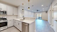 Located at 274 South Ave in Fanwood, NJ, this thoughtfully designed one-bedroom, one-bathroom residence offers a bright, modern living experience across a well-appointed single floor. Light wood-tone flooring flows throughout, complementing the crisp white walls and recessed lighting that give the space a clean, airy feel.

The open-concept kitchen is a standout feature, boasting white shaker cabinetry with matte black hardware, quartz countertops, a classic subway tile backsplash, and a full suite of stainless steel appliances. Gold-accented pendant lights add a refined touch above the peninsula, which opens seamlessly into the combined dining and living area. A ceiling fan and large sliding glass doors lead to a private balcony, filling the living space with natural light and offering outdoor views.

Near the entry, a built-in mudroom nook with bench seating and hooks provides practical storage. Three closets and dedicated hallways ensure ample organization throughout. The spacious bedroom features a ceiling fan, a generous window with outdoor views, and light-filled proportions. The bathroom is elegantly finished with marble-look tile flooring, a tiled tub-surround, and a backlit vanity mirror. A dedicated in-unit laundry area adds everyday convenience to this polished Fanwood residence.