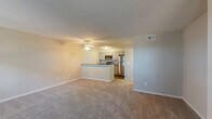 Located at 2274 Ashley River Rd in Charleston, SC, this one-bedroom, one-bathroom residence offers a well-organized single-floor layout designed for comfortable everyday living. The open-concept living and kitchen area forms the heart of the home, where plush carpeting and multiple large windows with blinds fill the space with abundant natural light and a warm, welcoming ambiance. A ceiling fan adds practical comfort to the living area. The kitchen is thoughtfully appointed with gray shaker-style cabinetry, granite-style countertops, a stainless steel refrigerator, built-in microwave, dishwasher, and electric range. A peninsula counter separates the kitchen from the living area, creating a natural flow between the two spaces while maintaining an open feel. Wood-look flooring in the kitchen adds a clean contrast to the carpeted living areas. The bedroom is a comfortable, well-proportioned retreat featuring soft carpet, neutral gray walls, a window for natural light, and direct access to the bathroom. The bathroom includes a full-size tub and shower combination with clean, white surrounds. A dedicated closet and hallway complete the efficient, functional layout of this Charleston-area residence.