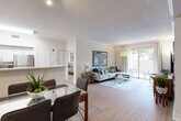 Located in Miami Lakes, FL, this well-appointed 2-bedroom, 2-bathroom single-floor residence offers a thoughtfully designed layout that maximizes comfort and functionality. The open-concept living, dining, and kitchen area forms the heart of the home, featuring light wood-look flooring, crown molding, and a textured ceiling. The kitchen is equipped with white cabinetry, stainless steel appliances, and a peninsula with a breakfast bar that seamlessly connects to the dining and living spaces. Sliding glass doors in the living room flood the area with natural light and open to a private patio with outdoor views.

Both bedrooms feature plush carpeting, ceiling fans, and large windows fitted with blinds that bring in generous natural light. The generously sized primary bedroom includes a spacious walk-in closet with wire shelving for practical organization. A total of six closets throughout the residence ensures abundant storage. The two bathrooms are finished with tile flooring and white vanities; one includes a soaking tub with shower combination. A dedicated laundry area and connecting hallway complete the efficient floor plan, making this a well-rounded and comfortable residence in a convenient Miami Lakes location.