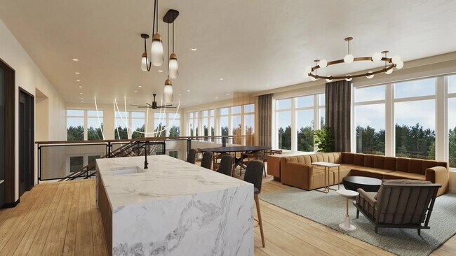 El salón en la azotea del segundo piso de los apartamentos Modera Shoreline cuenta con una cocina de demostración, un comedor y cómodos asientos. - Modera Shoreline