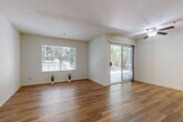 Located at 1333 S Belardo Rd in Palm Springs, California, this single-floor, one-bedroom, one-bathroom residence offers a clean and functional layout with consistent wood-look flooring flowing throughout every room. The open living area is bright and welcoming, featuring a large picture window and a sliding glass door that fills the space with natural light while providing direct access to the outdoors. A ceiling fan adds comfort and practicality to this central gathering space. The kitchen is well-appointed with white cabinetry, granite-style countertops, stainless steel appliances including a dishwasher and refrigerator, and a window above the sink that lets in additional natural light. The bedroom is a comfortable, well-proportioned room with a window overlooking greenery, rich hardwood-style flooring, and a mirrored sliding closet that enhances the sense of space. A hallway connects the main living areas, leading to the full bathroom, which features white cabinetry, a granite-topped vanity with a vessel sink, a mirrored medicine cabinet, and a full tub-shower combination. The entry foyer provides a clean transition into the home. With its bright white walls, cohesive flooring, and well-organized layout, this Palm Springs residence presents a tidy, modern, and move-in-ready living environment.