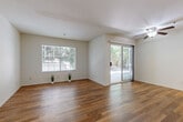 Located at 1333 S Belardo Rd in Palm Springs, California, this single-floor, one-bedroom, one-bathroom residence offers a clean and functional layout with consistent wood-look flooring flowing throughout every room. The open living area is bright and welcoming, featuring a large picture window and a sliding glass door that fills the space with natural light while providing direct access to the outdoors. A ceiling fan adds comfort and practicality to this central gathering space. The kitchen is well-appointed with white cabinetry, granite-style countertops, stainless steel appliances including a dishwasher and refrigerator, and a window above the sink that lets in additional natural light. The bedroom is a comfortable, well-proportioned room with a window overlooking greenery, rich hardwood-style flooring, and a mirrored sliding closet that enhances the sense of space. A hallway connects the main living areas, leading to the full bathroom, which features white cabinetry, a granite-topped vanity with a vessel sink, a mirrored medicine cabinet, and a full tub-shower combination. The entry foyer provides a clean transition into the home. With its bright white walls, cohesive flooring, and well-organized layout, this Palm Springs residence presents a tidy, modern, and move-in-ready living environment.
