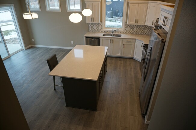 Looking from stair landing to the large kitchen (Photos are of similar unit with similar finishes.) - 3811 Stacy Drive