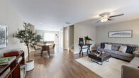 Located in Smyrna, Tennessee, this two-story, two-bedroom, three-bathroom home offers a well-organized layout spread across two evenly sized floors. The main level welcomes you with rich hardwood-style flooring that flows through a comfortable living room, complete with a ceiling fan and natural light from a large window. Adjacent to the living area, the kitchen features dark cabinetry, stainless steel appliances, and a sliding glass door that opens to a private outdoor patio — ideal for casual indoor-outdoor living. A convenient half-bath is also located on the main floor. Upstairs, the primary bedroom is a generously sized retreat with plush carpeting, ample natural light, and access to a walk-in closet outfitted with wire shelving. The second bedroom is similarly well-appointed with carpeted floors and a bright window. Both upper-level bathrooms are finished with tile flooring, dark vanity cabinetry, and tub-shower combinations. A dedicated laundry room on the upper floor adds everyday convenience. Throughout, the home maintains a neutral, warm palette with clean white trim, creating a cohesive and inviting atmosphere across all spaces.