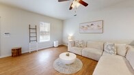 Located at 3003 Transport St SE in Albuquerque, New Mexico, this two-story home offers five bedrooms and five bathrooms spread across two well-proportioned floors. The main level features a bright, open living room with wood-look flooring, a ceiling fan, and natural light from large windows. The kitchen is thoughtfully designed with rich, warm-toned cabinetry, granite-style countertops, stainless steel appliances including a range, microwave, and dishwasher, and a deep double-basin sink — all complemented by wood-look flooring and recessed lighting. A staircase with classic wooden balusters connects the two floors, adding a traditional architectural touch to the entryway. Each of the five bedrooms features plush carpet flooring and direct access to a private bathroom, providing convenience and privacy throughout. The bedrooms are bright and comfortable, with windows allowing natural light and ample space for furnishings. The bathrooms are consistently finished with granite-topped vanities, tile flooring, and tub-shower combinations. The primary bedroom includes its own en-suite bath and a dedicated closet. Neutral tones and clean finishes are carried throughout the home, creating a cohesive and welcoming atmosphere across all spaces.