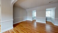Located in Richmond, VA's desirable 23221 zip code, this well-appointed 1-bedroom, 1-bathroom home offers a thoughtfully designed layout that maximizes every inch of its single-floor footprint. Warm hardwood floors run throughout, lending a cohesive and inviting feel to the entire space.

The kitchen is a standout feature, showcasing white shaker-style cabinetry with gold-toned hardware, sparkling speckled quartz countertops, a classic subway tile backsplash, and stainless steel appliances including a gas range and dishwasher. A window above the sink brings in natural light and views of the surrounding neighborhood.

The spacious bedroom is highlighted by charming vaulted ceilings with angled rooflines that add architectural character, along with multiple windows that fill the room with natural light. A dedicated closet provides practical storage.

The bathroom is clean and modern, featuring a white vanity topped with speckled quartz, chrome fixtures, a medicine cabinet mirror, and a crisp, neutral color palette. The living room offers a comfortable, open area complemented by the same warm hardwood flooring found throughout the home. An entrance area provides a welcoming transition into the space, completing this efficient and stylish Richmond home.