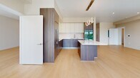 This contemporary 2-bedroom, 2.5-bathroom residence in Roseville, CA offers a thoughtfully designed open-concept layout with light wood flooring throughout and a clean, neutral color palette that enhances the sense of spaciousness. The living area is bathed in natural light from oversized floor-to-ceiling windows and sliding glass doors that frame panoramic views of the surrounding neighborhood and mature tree canopy, complemented by a wall-mounted mini-split system for efficient climate control.

The chef's kitchen is a standout feature, showcasing two-tone cabinetry with rich wood-grain lower cabinets and crisp white upper cabinets, a large waterfall-edge island, stainless steel appliances including built-in double wall ovens, and modern circular pendant lighting that adds a stylish focal point.

The generously sized primary bedroom connects to a well-organized walk-in closet with built-in shelving and a multi-drawer dresser unit. Each bathroom is finished with modern vanities featuring backlit mirrors, wood-grain cabinetry, vessel sinks, and a tub-shower combination. Recessed lighting throughout maintains a clean, contemporary aesthetic. Two dedicated closets provide ample storage across the home, rounding out this well-appointed Roseville residence.