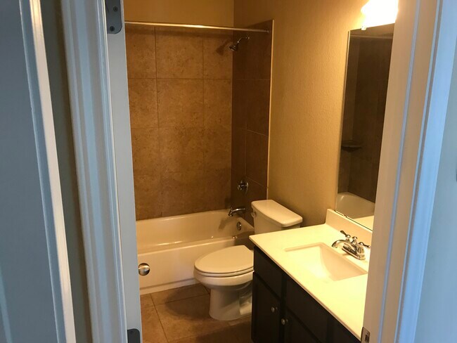 Bathroom off entry hallway by first and second bedrooms. - 5825 Worthing