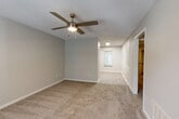 Located at 2901 Leah Court NW in Concord, NC, this one-bedroom, one-bathroom single-floor unit offers a well-organized and efficiently designed layout. The interior features a neutral color palette of soft grays and warm beiges throughout, creating a cohesive and calming atmosphere.

The kitchen is a functional highlight, showcasing gray shaker-style cabinetry paired with light countertops and a classic subway tile backsplash. Black appliances — including a refrigerator, range, and dishwasher — complement the cabinetry, while light wood-look flooring adds a clean, contemporary feel.

The spacious bedroom is finished with plush carpeting and features two reach-in closets, providing generous storage. A ceiling fan with integrated lighting adds comfort and functionality. Natural light filters in through a window with blinds, brightening the room.

The bathroom continues the modern aesthetic with gray vanity cabinetry, a light countertop, and wood-look tile flooring, maintaining design consistency with the rest of the unit.

The hallway area includes a window overlooking greenery, a chair rail detail, and wood-look flooring, serving as a practical transition space. A textured ceiling finish is present throughout, adding subtle architectural character to the overall design.