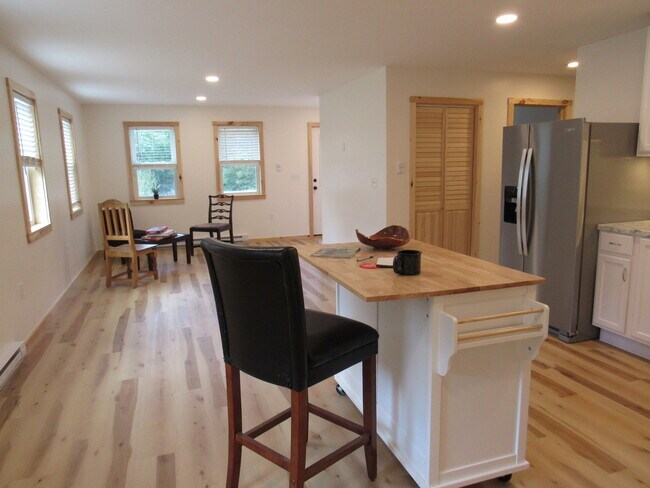 Living area with space for dining plus a wheeled island/breakfast bar - 57 River Rd