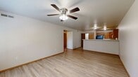 Located at 201 Southridge Rd in Tahlequah, Oklahoma, this single-floor, 2-bedroom, 2-bathroom residence offers a practical and comfortable layout designed for everyday living. The open-concept living room features light wood-look LVP flooring, a ceiling fan with light fixture, and a large window that invites natural light and outdoor views, creating a bright and welcoming atmosphere. A peninsula counter seamlessly connects the living area to the kitchen, which is outfitted with warm honey-toned wood cabinetry, white laminate countertops, a double stainless steel sink, and black appliances including an electric range with overhead ventilation. A dedicated laundry area with washer and dryer hookups adds everyday convenience. Both bedrooms are carpeted and feature ceiling fans, neutral walls, and ample closet space — the primary bedroom includes two closets and an en-suite bathroom. Each bathroom is clean and functional, featuring a full tub-shower combo, wood-toned cabinetry, LVP flooring, and brushed nickel fixtures. A connecting hallway ties all rooms together efficiently. This residence offers a straightforward, move-in-ready floor plan suited for comfortable living in a residential Tahlequah neighborhood.