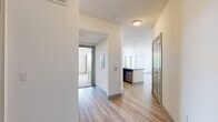 Located in College Station, Texas, this single-floor residence offers a thoughtfully designed layout with 2 bedrooms, 3 bathrooms, and a seamless open-concept living space. Light-toned hardwood-style flooring runs throughout the main living areas, complemented by neutral walls that create a bright, clean aesthetic.

The kitchen serves as a functional centerpiece, featuring rich dark-wood cabinetry, granite countertops, stainless steel appliances, and a large central island with a built-in sink and pendant lighting overhead. The kitchen flows naturally into the living room, which benefits from large windows and a sliding glass door that invite natural light and outdoor views.

Both bedrooms are carpeted for comfort and equipped with ceiling fans. The generously sized primary bedroom connects directly to its own bathroom and a walk-in closet outfitted with wire shelving on multiple walls. The second bedroom is served by its own bathroom as well, featuring a granite-topped vanity with dark cabinetry and hardwood-style flooring. A third bathroom adds further convenience for guests. Each bathroom maintains a consistent, clean design with granite counters and dark wood vanities. Two walk-in closets provide ample storage throughout the residence.