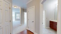 Located at 301 Colt Hwy in Farmington, CT, this single-floor residence offers a thoughtfully designed layout across a comfortable footprint. The open-concept kitchen and dining area serves as the heart of the home, featuring warm cherry wood cabinetry, granite countertops, stainless steel appliances including a refrigerator, microwave, and range, and a central island with pendant lighting overhead. Multiple windows flood the adjoining living area with natural light, complementing the neutral carpet and light-toned walls throughout.

The primary bedroom is a generously sized retreat, complete with a walk-in closet equipped with wire shelving for organized storage. The second bedroom is well-proportioned with its own window providing outdoor views and ample natural light. Both rooms feature soft carpet flooring and neutral grey walls.

The two bathrooms are finished with tile flooring, warm wood vanities, and white countertops. One bathroom includes a walk-in shower, while the other features a grab bar for added accessibility. Six-panel white interior doors and crown molding in key areas add classic architectural detail. A dedicated laundry room with full-size washer and dryer and wire shelving completes the unit's practical amenities.