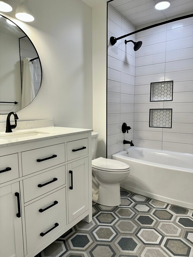 Bathroom with tub and shower. - 4600 36th Ave S