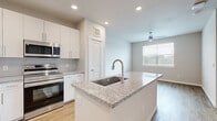Located at 22540 Merchants Way in Houston, TX, this 1-bedroom, 1-bathroom residence offers a thoughtfully designed single-floor layout that maximizes every square foot. Warm hardwood-style flooring runs throughout, creating a cohesive and inviting atmosphere across all rooms.

The kitchen is a standout feature, showcasing white shaker cabinetry, granite countertops, a subway tile backsplash, and a full suite of stainless steel appliances including a range, microwave, dishwasher, and French door refrigerator. A central island with an undermount sink adds both prep space and a natural gathering point that opens to the adjacent dining area.

The living and dining areas are bright and airy, benefiting from natural light filtered through large windows with slatted blinds and a ceiling fan overhead. The bedroom is a comfortable, well-proportioned retreat with its own window offering natural light and outdoor views.

The full bathroom features a tub-shower combination with marble-style tile surround, a granite-topped vanity with white cabinetry, and hardwood-style flooring. Directly accessible from the bathroom is a spacious walk-in closet outfitted with wire shelving on three walls, offering generous and organized storage. The overall design is clean, modern, and move-in ready.