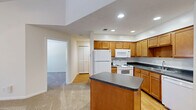 Located at 6650 Creek Bay Dr in Indianapolis, IN, this single-floor residence offers a comfortable and functional layout. The open-concept living area seamlessly connects the dining room, kitchen, and living room, creating an inviting and versatile space. The kitchen is well-equipped with warm honey-toned cabinetry, dark granite-style countertops, a center island with additional prep space, recessed lighting, and wood-look flooring. A pendant light over the dining area adds a charming touch.

The bedroom is a generous, carpeted retreat featuring vaulted ceilings, a ceiling fan, and a sliding glass door that opens to a private balcony with outdoor views — an ideal spot to enjoy natural light and fresh air. A closet provides convenient built-in storage. An additional carpeted room with a window and closet offers flexible use as a secondary space.

The full bathroom includes a tiled shower-tub combination, wood-look flooring, warm wood vanity cabinetry, and dark countertops, maintaining a consistent design aesthetic throughout. A utility room and multiple closets round out the practical storage solutions this residence provides, making it an efficient and well-organized home.