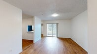 Located at 4963 Raleigh St in Orlando, Florida, this single-floor residence offers a practical and well-organized layout with two bedrooms and two bathrooms. Wood-style flooring runs throughout the home, providing a warm, cohesive look across every room.

The living area is open and bright, featuring a sliding glass door that fills the space with natural light and provides views of the outdoors. A pass-through opening connects the living and dining areas to the kitchen, enhancing the sense of flow between spaces. The kitchen is equipped with warm wood cabinetry, black appliances including an electric range and dishwasher, and a window above the sink that brings in additional natural light. A dedicated laundry area is conveniently located just off the kitchen.

Both bedrooms offer clean, neutral walls, wood-style flooring, and textured ceilings. The primary bedroom is a comfortable size and features a closet with sliding doors. The second bedroom includes a window with exterior views. Each bedroom is served by its own bathroom — one featuring a vanity with wood cabinetry and a tiled tub-shower combination, and the other offering a pedestal sink, mirror, and tiled tub-shower. The home also includes a hallway, utility room, and a total of four closets, ensuring ample storage throughout.