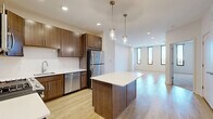 Located at 1 Woodbridge Center Dr in Woodbridge, NJ, this well-appointed 2-bedroom, 2-bathroom residence offers a thoughtfully designed single-level layout. The open-concept living, dining, and kitchen area serves as the heart of the home, featuring light wood-tone flooring that extends throughout the main living spaces. The kitchen is outfitted with rich walnut-toned cabinetry, stainless steel appliances including a refrigerator, gas range, microwave, and dishwasher, complemented by a white countertop peninsula with pendant lighting above. Tall, narrow windows allow natural light to filter into the space while framing outdoor views. The living area is generously proportioned, offering a bright and open ambiance with recessed lighting overhead. Both bedrooms are carpeted for comfort, with the primary bedroom featuring dual floor-to-ceiling windows that bring in abundant daylight and outdoor scenery, along with ample closet space. The unit includes four closets in total, providing excellent storage throughout. The bathrooms are finished with light tile flooring and wood-tone vanities. A dedicated utility room houses the in-unit washer/dryer and water heater, adding everyday convenience to this clean, modern residence.