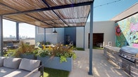 The Sky Lounge is a thoughtfully designed rooftop outdoor space that seamlessly blends comfort, art, and functionality. The layout is organized into several distinct zones, each serving a unique purpose while contributing to a cohesive, inviting atmosphere. A steel-framed pergola with a woven reed canopy provides filtered shade over key gathering areas, with industrial-style pendant lights hanging overhead and string lights adding ambiance. Beneath the pergola, lush raised planters filled with flowering plants and ornamental grasses introduce natural greenery and visual texture against the grey modern palette of the surrounding walls. A central turf lawn anchors a lounge seating area furnished with generous grey sofas arranged around a sleek rectangular fire pit table, creating an ideal setting for relaxed socializing. An outdoor kitchen station equipped with a full-size grill offers space for cooking and entertaining. A bold, large-scale botanical mural rendered in vibrant pinks, greens, and blues commands attention as a striking artistic focal point. Additional dining seating with yellow chairs adds a pop of color throughout. Open sightlines on multiple sides allow for panoramic sky and cityscape views.