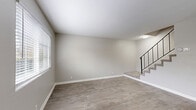 Located at 765 McMurray Drive in Nashville, TN, this two-story home offers a practical and well-designed layout spread across two floors. The main level features an open living area with light wood-style luxury vinyl flooring, neutral gray walls, and clean white baseboards that create a bright, cohesive atmosphere. Natural light filters in through windows fitted with horizontal blinds, enhancing the airy feel of the space. A staircase with a modern black metal railing connects the two floors, serving as a subtle architectural accent.

The kitchen is a standout feature, outfitted with white shaker-style cabinetry, white quartz countertops, a subway tile backsplash, a stainless steel sink, and stainless steel appliances. The wood-style flooring continues throughout, maintaining a consistent aesthetic.

Upstairs, two carpeted bedrooms offer a comfortable retreat. The spacious primary bedroom includes a built-in closet and a large window with views of the surrounding greenery. The second bedroom is also well-sized and carpeted. The full bathroom features a white vanity with quartz countertop, a tub-shower combo, and wood-style flooring. A hallway and closet round out the upper level, providing practical storage and circulation throughout this efficiently designed Nashville home.