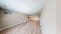 Located at 873 Westbury Blvd in Howell, MI, this single-floor, 2-bedroom, 2-bathroom home offers a well-organized layout with clean, modern finishes throughout. The open-concept living room is spacious and bright, featuring light-toned luxury vinyl plank flooring and neutral wall tones that create an airy, welcoming atmosphere. The kitchen is thoughtfully designed with white cabinetry, light countertops, stainless steel appliances including a refrigerator, range, microwave, and dishwasher, and continues the same LVP flooring for a cohesive look. Both bedrooms are carpeted and receive natural light through windows with blinds, offering a comfortable and quiet retreat. The primary bedroom is generously sized with ample room for furnishings. The two bathrooms are finished with white vanity cabinetry, light stone countertops, LVP flooring, and tub-shower combinations. A dedicated laundry room houses a full-size washer and dryer. The home also includes a closet for additional storage, a welcoming entrance, and an attached garage that opens to a residential neighborhood setting with mature trees and nearby homes visible from the driveway.