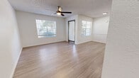 Located at 13150 Wenonah Ave SE in Albuquerque, NM, this single-floor, one-bedroom, one-bathroom unit offers a well-organized and efficiently designed layout with modern finishes throughout. The open living room is bright and welcoming, featuring light-toned luxury vinyl plank flooring, a textured ceiling, a ceiling fan with light fixture, and multiple windows fitted with blinds that invite natural light while maintaining privacy. A private entry door opens directly into this space, enhancing accessibility. The galley-style kitchen is thoughtfully appointed with white upper cabinetry, gray lower cabinetry, white quartz-style countertops, stainless steel appliances including a refrigerator, dishwasher, and range, as well as a built-in microwave and a single-basin sink. The bedroom is a comfortable retreat with plush carpeting, a ceiling fan, a window with natural light, and direct access to a dedicated closet outfitted with dual hanging rods and carpet flooring. The bathroom features gray cabinetry, a wide vanity mirror, light countertops, LVP flooring, and accessible grab bars. A dedicated in-unit laundry room with washer and dryer and built-in shelving adds everyday convenience to this clean, move-in-ready Albuquerque home.