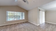 Located at 3225 Woodland Park Dr in Houston, TX, this single-floor, 3-bedroom, 3-bathroom home offers a well-designed layout with a mix of comfortable and functional spaces. The living room features plush carpeting, vaulted ceilings with a ceiling fan, and large windows that frame views of surrounding greenery, filling the space with abundant natural light. Crown molding adds a refined architectural touch to the common areas.

The kitchen is equipped with stainless steel appliances — including a refrigerator, range, microwave, and dishwasher — paired with dark granite countertops, a breakfast bar, and ample white cabinetry for storage. Light wood-style flooring runs throughout the kitchen and hallways, creating a clean, cohesive look.

Each of the three bedrooms is carpeted and features windows with blinds offering outdoor views of the lush landscape. The primary bedroom is notably spacious, enhanced by a tray ceiling with a ceiling fan and dual windows for extra light and ventilation. The three bathrooms are well-appointed with tub-shower combos, large vanity mirrors, and wood-style flooring. A dedicated laundry room with full-size washer and dryer connections and shelving adds everyday convenience to this inviting Houston home.