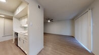 Located at 901 W Silver Sands Dr in San Antonio, TX, this single-floor residence offers a clean, updated interior with a cohesive neutral palette throughout. The kitchen is outfitted with white shaker-style cabinetry, light stone-look countertops, a double stainless steel sink with a pull-down faucet, a soft blue subway tile backsplash, and a black dishwasher. A window at the end of the kitchen brings in natural light, while the open layout connects seamlessly to the living area. The spacious living room features durable wood-look flooring, a ceiling fan with light fixture, a textured ceiling, and sliding glass door access to the exterior. The bedrooms are carpeted for comfort, each featuring ceiling fans, windows with blinds, and ample closet space, including a walk-in closet in at least one bedroom. Both bathrooms are finished with white cabinetry, granite-style countertops, brushed nickel hardware, large mirrors, and a full tub-shower combination with tile surround and wood-look flooring. The consistent finishes and bright, neutral tones throughout create a clean and functional living environment.