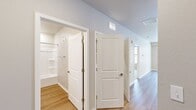 This 720 square foot apartment in Deerfield, Illinois offers a thoughtful layout that maximizes space efficiency. The single-floor plan includes one bedroom, one bathroom, and an open-concept living area. The modern kitchen is a standout feature, boasting white cabinetry, granite countertops, and stainless steel appliances, including a spacious refrigerator, built-in microwave, and electric range. A central island provides additional counter space and casual dining options.

The living room is bright and airy, with large windows and a glass door leading to an outdoor space, filling the area with natural light. The bedroom, measuring 150 square feet, includes a ceiling fan and window for ventilation. A walk-in closet offers ample storage space with wire shelving.

The bathroom features a combination tub-shower, single vanity with granite countertop, and wood-look flooring that complements the overall design. Throughout the apartment, a mix of carpet and wood-look flooring creates a cohesive aesthetic. The neutral color palette and clean lines contribute to a modern, inviting atmosphere, making this compact space feel open and welcoming.