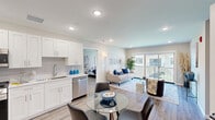 This well-appointed 2-bedroom, 2-bathroom residence at 266 Morris Ave in Long Branch, NJ offers a thoughtfully designed single-floor layout with a bright, open feel throughout. The open-concept kitchen and living area serves as the heart of the home, where white shaker cabinetry, a classic subway tile backsplash, light quartz countertops, and a full suite of stainless steel appliances — including a gas range, built-in microwave, dishwasher, and French door refrigerator — create a sleek, functional space. Recessed lighting and light-toned hardwood-style flooring run throughout, enhancing the airy atmosphere. The living room flows naturally from the kitchen and dining area, leading to a sliding glass door that opens to a private balcony with outdoor views. The spacious primary bedroom includes access to a walk-in closet and a dedicated en-suite bathroom featuring a large walk-in shower with floor-to-ceiling marble-style tile and a rainfall showerhead. The second bathroom offers a full tub-shower combination with matching marble-style tile surround and brushed nickel fixtures. The second bedroom includes a built-in closet and generous natural light. A utility room, hallway, and additional closet storage complete the practical layout of this modern Long Branch residence.