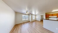 This single-story 2-bedroom, 2-bathroom unit offers a well-organized layout with light wood-style flooring throughout. The open living and dining area is bright and airy, featuring multiple windows that bring in natural light and ceiling fans for added comfort. The space flows naturally from the living area toward the kitchen, which is designed in a classic galley style with warm honey-toned wood cabinetry, dark countertops, and white appliances including a gas range, refrigerator, and dishwasher. A peninsula counter separates the kitchen from the dining area, enhancing the open feel.

Both bedrooms are comfortably sized, each equipped with ceiling fans and sliding closet doors, providing functional storage. The primary bedroom offers a generous footprint with windows on two walls, allowing for ample natural light. The unit includes four closets in total, ensuring plentiful storage throughout. Each bathroom is clean and functional, featuring a full tub-shower combination. Neutral wall tones and consistent flooring throughout create a cohesive and move-in ready aesthetic. A private patio adds outdoor living space, rounding out this practical and well-appointed unit.