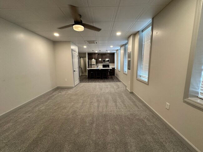 View from living room into kitchen, showing coat/storage closet on left. - 158 E Walnut St