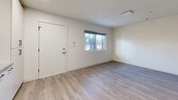 Located on Pico Boulevard in Santa Monica, California, this efficiently designed one-bedroom, one-bathroom unit offers a thoughtfully utilized single-floor layout with modern finishes throughout. Light-toned hardwood flooring extends across all rooms, creating a cohesive and clean aesthetic.

The open living area features crisp white walls, a window providing natural light, and a minimalist feel that maximizes the sense of space. The kitchen is well-appointed with floor-to-ceiling white cabinetry, a classic white subway tile backsplash, quartz countertops, and a full suite of stainless steel appliances including a gas range, built-in microwave, dishwasher, and refrigerator. Recessed lighting and a matte black faucet add refined modern touches.

The bedroom is a comfortable, well-proportioned space equipped with a ceiling fan, a window with a roller shade, and a mirrored closet that enhances the room's brightness. An additional dedicated closet features wire shelving for organized storage.

The bathroom is finished in a clean, contemporary style with large-format white tile surrounding the shower-tub combo, a wall-mounted vanity, matte black fixtures, and a mirrored medicine cabinet. The unit's consistent design language and quality finishes make it a polished, functional living space.