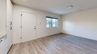 Located on Pico Boulevard in Santa Monica, California, this efficiently designed one-bedroom, one-bathroom unit offers a thoughtfully utilized single-floor layout with modern finishes throughout. Light-toned hardwood flooring extends across all rooms, creating a cohesive and clean aesthetic.

The open living area features crisp white walls, a window providing natural light, and a minimalist feel that maximizes the sense of space. The kitchen is well-appointed with floor-to-ceiling white cabinetry, a classic white subway tile backsplash, quartz countertops, and a full suite of stainless steel appliances including a gas range, built-in microwave, dishwasher, and refrigerator. Recessed lighting and a matte black faucet add refined modern touches.

The bedroom is a comfortable, well-proportioned space equipped with a ceiling fan, a window with a roller shade, and a mirrored closet that enhances the room's brightness. An additional dedicated closet features wire shelving for organized storage.

The bathroom is finished in a clean, contemporary style with large-format white tile surrounding the shower-tub combo, a wall-mounted vanity, matte black fixtures, and a mirrored medicine cabinet. The unit's consistent design language and quality finishes make it a polished, functional living space.