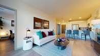 Located at 1 Buttonwood Ct in Madison, Wisconsin, this single-floor residence offers a thoughtfully designed open-concept layout with clean, modern finishes throughout. The living area is bright and welcoming, featuring light wood-style flooring, neutral walls, and recessed lighting. A comfortable seating arrangement anchors the space, accented by bold throw pillows and a sleek glass coffee table, with framed artwork adding a refined touch to the walls.

The kitchen is well-equipped with stainless steel appliances, including a French door refrigerator, electric range, and built-in microwave. White flat-front cabinetry extends to the ceiling, complemented by a textured tile backsplash, providing ample storage and a polished aesthetic. A bar-height counter with seating connects the kitchen seamlessly to the living area.

The bedrooms are comfortably sized, each featuring light flooring, natural light through large windows with exterior views, and ceiling fans for added comfort. The primary bathroom impresses with a long dual-sink vanity topped in white quartz, wood-framed mirror, glass-enclosed shower, and direct access to a spacious walk-in closet. A secondary bathroom offers a full tub-shower combination with clean white finishes. The overall ambiance is modern, cohesive, and move-in ready.
