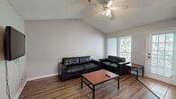 Located in Tallahassee, FL 32303, this single-story residence offers 2 bedrooms, 3 bathrooms, a dedicated office, a dining room, a living room, and an in-unit laundry room. The living room is a standout space, featuring a vaulted ceiling with a ceiling fan, wood-look flooring, and large windows with a glass door that invite natural light and provide views of the surrounding greenery. An open pass-through counter connects the living area to the kitchen, enhancing the sense of openness. The dining area features tile flooring and a wall-mounted light fixture, providing a defined space for meals. Both bedrooms are carpeted and equipped with ceiling fans and window blinds, offering a comfortable and quiet retreat. The primary bedroom includes a mirrored sliding closet, while the secondary bedroom benefits from natural light through a double window. A dedicated office nook with a mirrored closet adds versatile functionality. The three bathrooms feature tile flooring and include a combination tub-shower, vanity mirrors, and built-in shelving in one unit. A wire-shelf storage area is accessible from one of the bathrooms, adding practical storage. The textured ceilings throughout give the home a consistent finish.