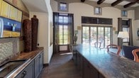 Located at 29675 N North Valley Pkwy in Phoenix, AZ, this single-floor residence offers a thoughtfully designed layout with a cohesive, contemporary aesthetic. The kitchen is equipped with dark espresso cabinetry, black appliances including a range, built-in microwave, and full-size refrigerator, complemented by light countertops and wood-look flooring that adds warmth to the space. Crown molding and natural light from a large window enhance the kitchen's clean, functional design.

The living area is spacious and inviting, featuring plush carpeting, crown molding, and multiple windows dressed with elegant drapes and blinds that allow for abundant natural light. A ceiling fan adds comfort, and the open layout provides ample room for relaxed living and entertaining.

The bedrooms are generously sized with soft carpeting, ceiling fans, and striking accent walls in bold terracotta tones that lend a vibrant character to each room. Mirrored sliding closet doors maximize the sense of space, and each bedroom offers convenient access to well-appointed bathrooms. The bathrooms feature dark vanity cabinetry, countertop sinks with large mirrors, tub-shower combinations, and wood-look flooring, creating a polished and practical finish throughout.