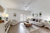 Located at 425 Rayford Rd in Spring, TX, this well-appointed single-story home offers a thoughtfully designed open-concept layout that seamlessly connects the living, dining, and kitchen areas. The bright living room features wood-look flooring, a ceiling fan with light fixture, a textured ceiling, and French doors that open to a private patio, filling the space with natural light. The kitchen is equipped with gray cabinetry, black appliances, a granite-topped peninsula with bar seating, and recessed lighting, flowing naturally into the adjacent dining area accented with wainscoting and decorative wall details. The spacious bedroom is carpeted for comfort and includes a ceiling fan, a generous walk-in closet, and a window that brings in natural light. The bathroom features a full soaking tub and shower combination with built-in tiled shelving and clean white finishes throughout. Additional highlights include a dedicated laundry area, two closets for ample storage, and a covered patio. The overall aesthetic carries a warm farmhouse-inspired charm with neutral tones and tasteful detailing throughout.