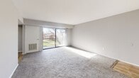 Located at 155 E Godfrey Ave in Philadelphia, PA, this two-bedroom, one-bathroom residence offers a well-organized single-floor layout with a comfortable and functional design throughout.

The living room is a generously sized, light-filled space featuring soft carpeting and a large sliding glass door that opens onto a private balcony. The balcony overlooks a landscaped courtyard with mature trees and open green space, providing a pleasant outdoor retreat.

The kitchen is well-appointed with crisp white cabinetry, gray countertops, stainless steel appliances including a refrigerator, range, and dishwasher, and wood-look flooring. A peninsula counter adds additional workspace and a natural division between the kitchen and living areas. Natural light filters in through multiple windows fitted with blinds.

The primary bedroom is a spacious, carpeted room with neutral gray walls and a window that brings in natural light. The second bedroom, also carpeted, offers a quieter, more compact layout suitable as a guest room or home office.

The bathroom features a full tub-shower combination with classic white subway tile surround, maintaining a clean and timeless aesthetic. Throughout the residence, neutral tones and consistent finishes create a cohesive and move-in-ready environment.