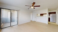 Located in Mesquite, TX, this one-bedroom, two-bathroom residence offers a well-organized single-floor layout designed for comfortable everyday living. Light wood-style flooring runs throughout the space, creating a clean, cohesive aesthetic that brightens each room. The open living area is a welcoming centerpiece, featuring a ceiling fan with integrated lighting, a textured ceiling, and a sliding glass door dressed with vertical blinds that allows natural light to pour in and provides access to an outdoor area. A pass-through counter connects the living area to the kitchen, which is appointed with dark wood cabinetry and light countertops, offering a functional and visually grounded cooking space. The bedroom is generously proportioned, featuring its own ceiling fan, a window with natural views, and direct access to an en suite bathroom. The en suite includes dark wood vanity cabinetry and is complemented by a second full bathroom featuring large-format neutral tile surrounding a full soaking tub. Three closets throughout the unit provide ample storage. The consistently neutral color palette, abundant natural light, and thoughtful layout make this a practical and inviting space.