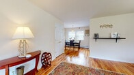 Located at 115 Old Short Hills Rd in West Orange, NJ, this single-floor residence offers a well-organized and functional layout with a warm, comfortable ambiance throughout. Rich hardwood flooring flows seamlessly across the main living areas, lending a cohesive and inviting feel to the entire space.

The entryway welcomes visitors with a decorative console table and a colorful area rug, opening directly into a bright and airy living room. The living room features large windows that allow generous natural light to fill the space, offering views of the surrounding greenery outside.

Adjacent to the living area, the dining room is illuminated by a classic pendant light fixture and benefits from additional natural light through sizable windows. A set of double closet doors provides convenient storage within the dining space.

The kitchen is outfitted with warm oak cabinetry, granite-style countertops, a stainless steel sink, and white appliances including a gas range and dishwasher. A window above the sink brings in natural light, and tile backsplash detailing adds a clean, finished look.

The bedroom is a quiet, well-proportioned retreat with the same warm hardwood flooring, neutral walls, and ample space for furnishings. The bathroom features light tile flooring, an oak vanity with under-cabinet storage, a wall mirror with overhead lighting, and a window for natural ventilation.