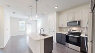 This sleek 640 square foot apartment offers a harmonious blend of comfort and contemporary design. The open floor plan maximizes the use of space, creating a seamless flow between the living areas. The modern kitchen is a standout feature, boasting a stylish two-tone cabinet design with light upper and dark lower cabinets, complemented by stainless steel appliances and a subtle backsplash.

The living room is bathed in natural light thanks to large windows, and a ceiling fan adds both style and functionality. The bedroom, measuring 150 square feet, provides a cozy retreat with ample space for a queen-sized bed and additional furniture. The bathroom continues the modern aesthetic with a floating vanity and a shower/tub combination.

Convenience is key in this unit, with an in-unit laundry room featuring full-sized washer and dryer. The apartment also includes three closets for ample storage. Throughout the space, neutral-toned walls and light wood-look flooring create a bright, airy atmosphere that serves as a perfect canvas for personal decor. Located in the UDR Essex Luxe complex in Orlando, this apartment offers a perfect blend of style, comfort, and practicality in its compact yet well-designed layout.