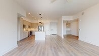 Located at 468 Quay Commons in the heart of Sarasota, FL 34236, this well-appointed 3-bedroom, 2-bathroom residence offers a thoughtfully designed single-floor layout. The open-concept living and kitchen area serves as the centerpiece of the home, featuring light wood-tone flooring that flows seamlessly throughout. The kitchen is equipped with stainless steel appliances, soft gray shaker-style cabinetry extending to the ceiling, a classic subway tile backsplash, and a spacious central island with a crisp white quartz countertop. Stylish globe pendant lights add a modern touch overhead. The generous living area benefits from access to a balcony, allowing natural light to fill the space. The three bedrooms are well-proportioned, each with large windows fitted with blinds that invite natural light while maintaining privacy. The primary bedroom offers a comfortable retreat with ample room. Two bathrooms provide functional elegance, including a full bath with large-format tile flooring, a tub-shower combination with soft blue tile surround, and a vanity with matte black hardware accents. A dedicated laundry area and four closets round out the practical amenities of this clean, contemporary Sarasota residence.