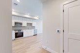 Located in Denver's vibrant 80220 corridor, this thoughtfully designed one-bedroom, one-bathroom residence offers a clean, modern aesthetic throughout. Light oak hardwood flooring flows seamlessly across the entire unit, creating a warm and cohesive feel.

The open-concept living, dining, and kitchen area serves as the heart of the home. The kitchen is outfitted with flat-front white cabinetry extending to the ceiling, stainless steel appliances including a French-door refrigerator, electric range, built-in microwave, and dishwasher, complemented by a herringbone tile backsplash and crisp white countertops. A dedicated pantry provides additional storage.

The living and dining area opens directly to a private balcony through large glass sliding doors, offering views of the surrounding Denver neighborhood and filling the space with abundant natural light.

The bedroom features a ceiling fan, double-door closet, and a calm, neutral palette. Two closets throughout the unit ensure ample storage. The bathroom includes a full soaking tub with an overhead shower, floor-to-ceiling large-format tile surround, and clean modern fixtures.

Additional conveniences include in-unit laundry, a dedicated entrance, and a smart thermostat, making this residence as functional as it is refined.