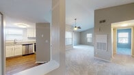 Located at 1900 Link Side Dr in Cincinnati, OH, this single-story home offers a well-designed layout with a cohesive blend of comfort and functionality. The living room serves as the centerpiece of the space, highlighted by vaulted ceilings that lend an airy, open feel. A ceiling fan complements the volume of the room, while multiple windows dressed with blinds allow generous natural light to fill the carpeted space. A tile-surround fireplace with a white mantel adds a classic focal point to the living area.

The kitchen is thoughtfully appointed with white cabinetry, granite countertops, a white subway tile backsplash, and stainless steel appliances including a range, microwave, and dishwasher. A pass-through counter connects the kitchen to the living area, enhancing the open flow of the floor plan. Wood-style flooring runs throughout the kitchen, contrasting with the carpet found in the living and bedroom areas.

The bedrooms are comfortably sized with vaulted ceiling details and natural light from exterior windows. The bathroom features wood-style vinyl flooring and a tub-shower combination with a clean, neutral finish. Overall, the space presents a bright, neutral palette suitable for a variety of lifestyles.
